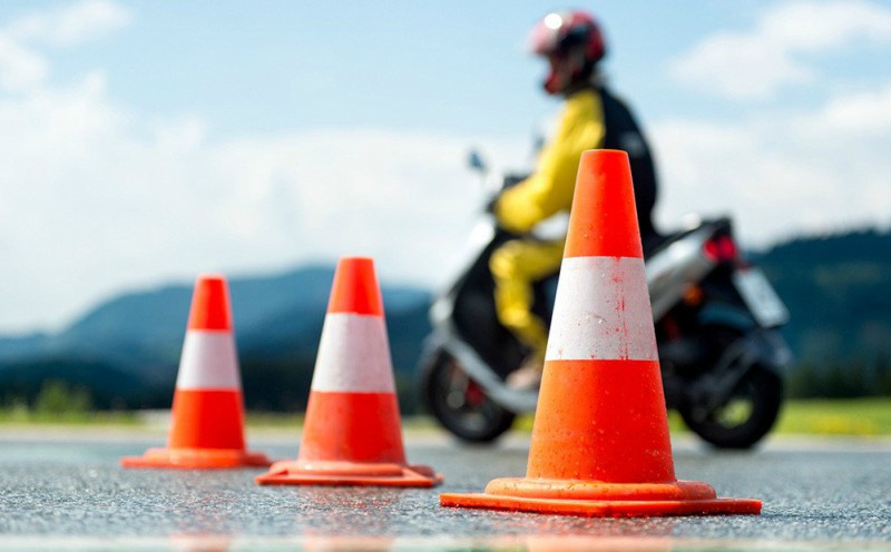 Profesor de la autoescuela MotoCircuito en Móstoles enseñando a un joven alumno las diferencias técnicas entre un ciclomotor y una motocicleta de 125cc para el carnet A1.