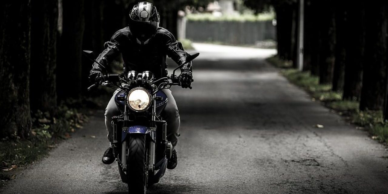 Profesor de MotoCircuito enseñando a un alumno dónde se encuentra el depósito del líquido de frenos de la motocicleta durante una clase en el circuito de Móstoles, preparándole para las verificaciones previas.